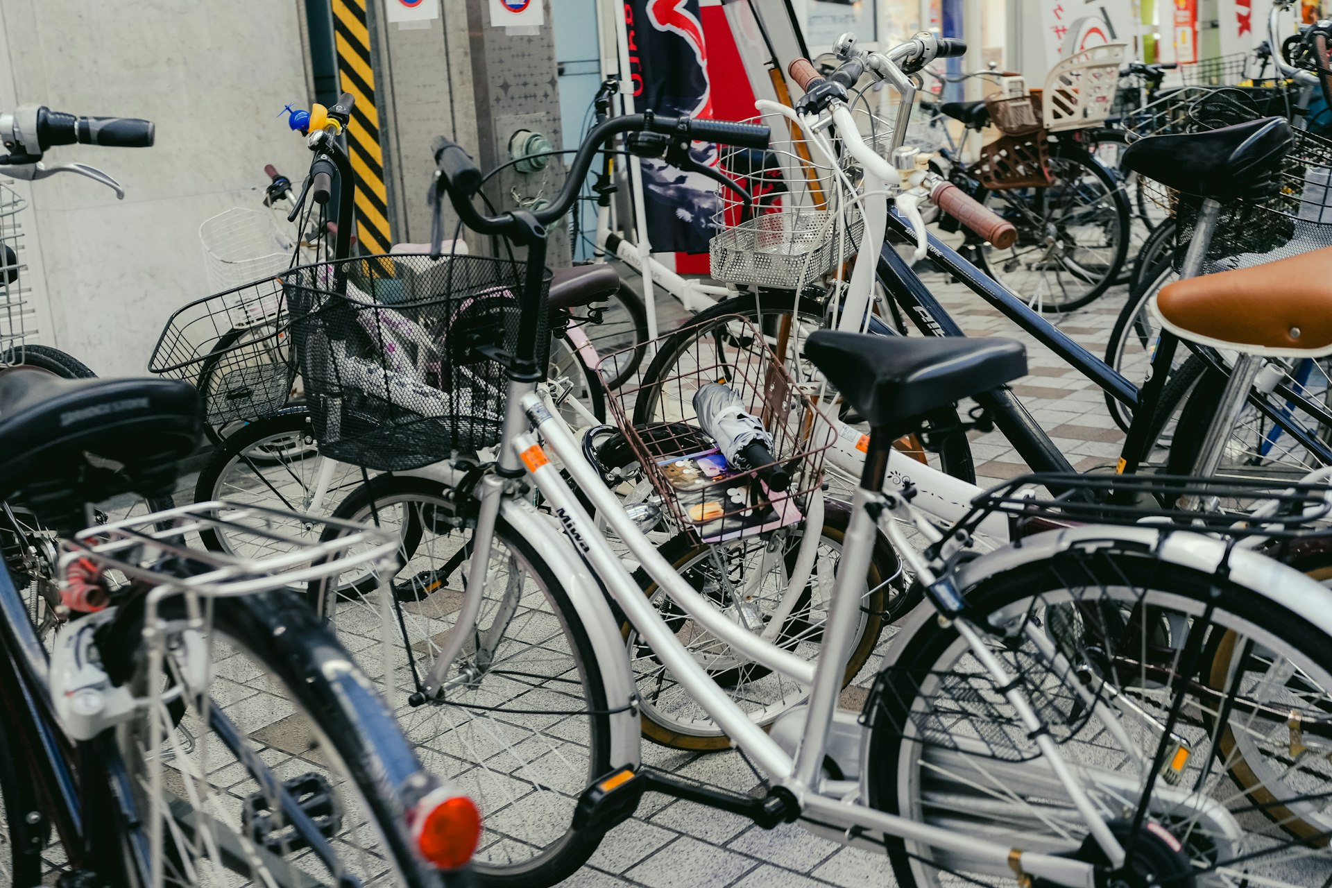 Many bicycles parked closely together on a street.